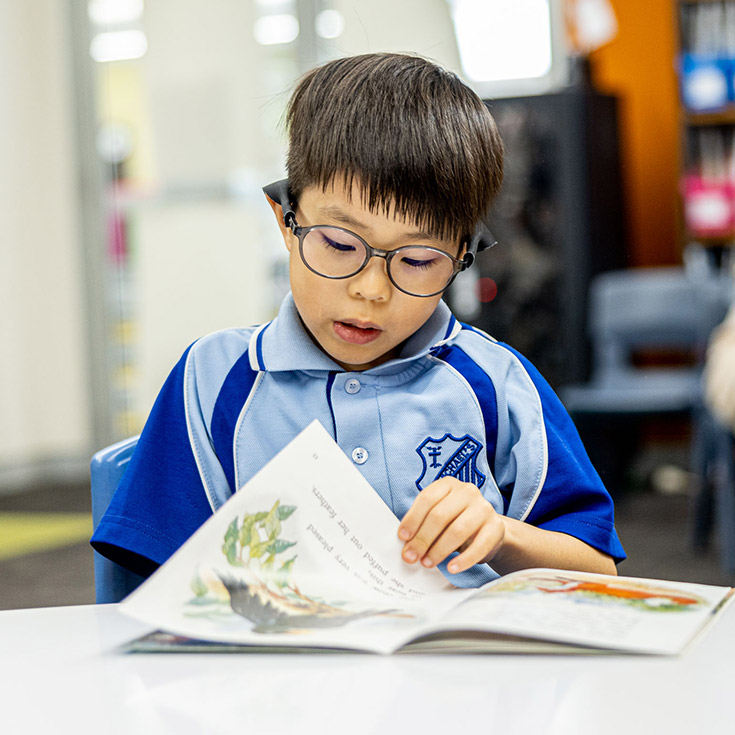 Student reading at St Michael's Catholic Primary Baulkham Hills